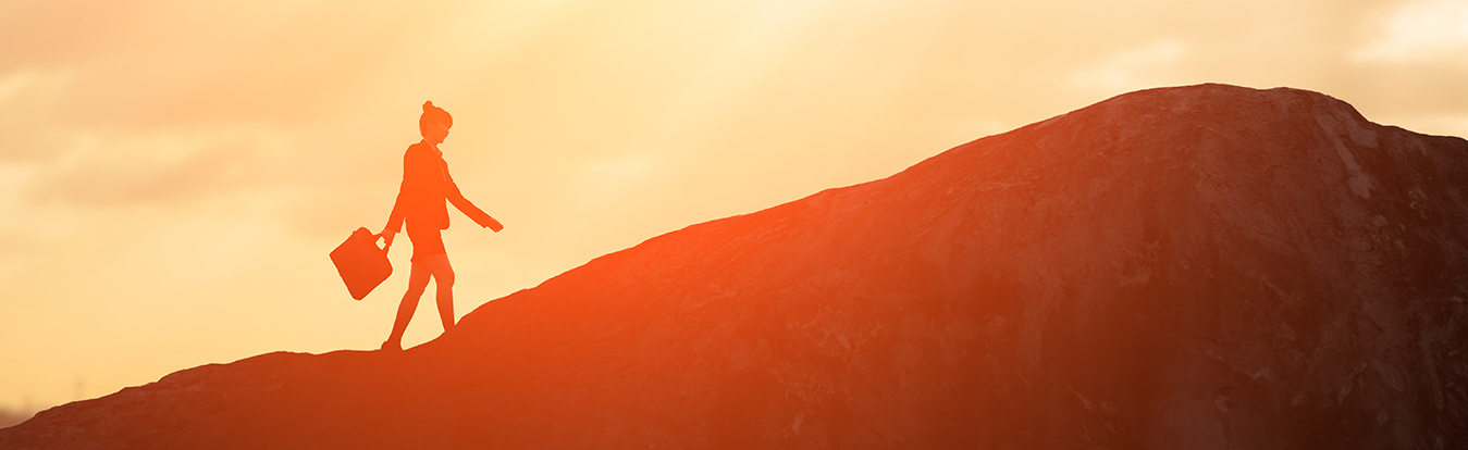 Image of a woman walking up a mountain